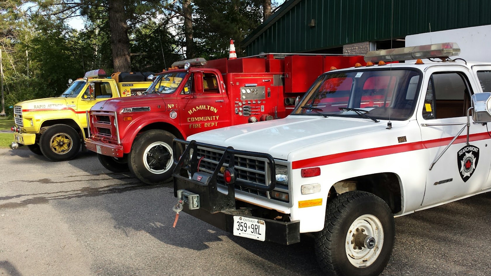 Rapid Attack unit, vintage pumper and Searchmont rescue pickup parked in a row
